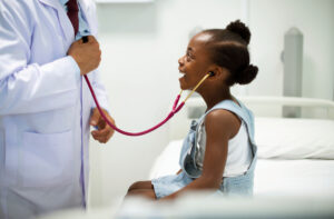 Doctor with child wearing stethoscope after PALS training in Tempe, AZ
