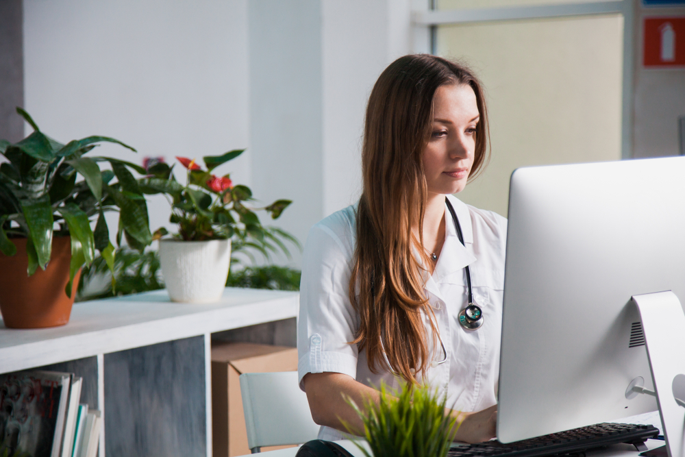 Medical professional at computer taking online BLS courses in Mesa, AZ