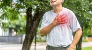 Senior aged man in park holding chest having medical emergency in Tempe, AZ